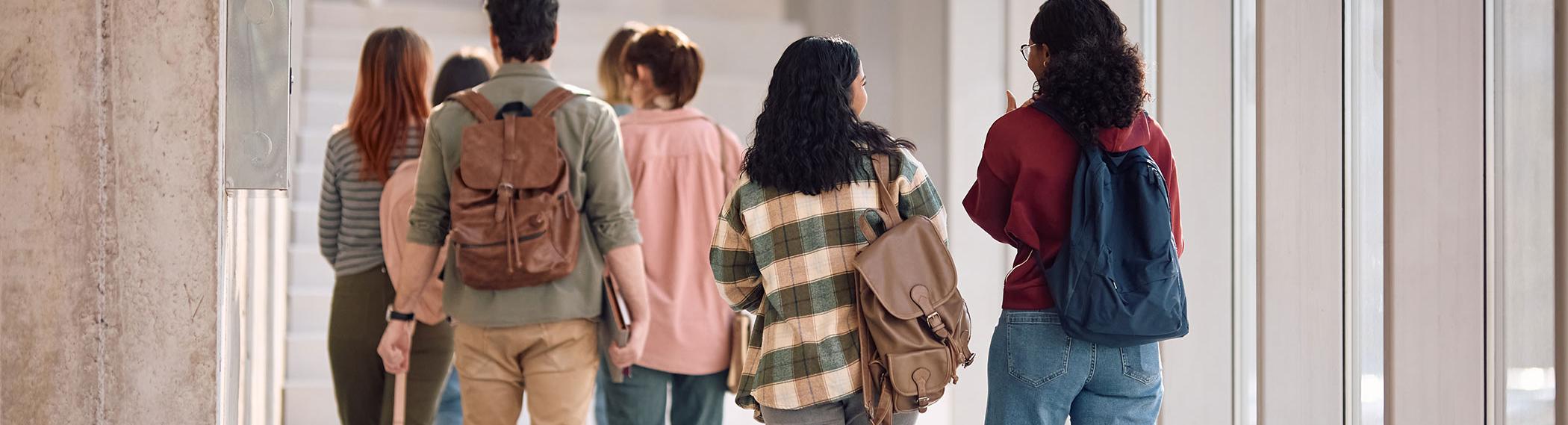 High school students walking towards stairs.