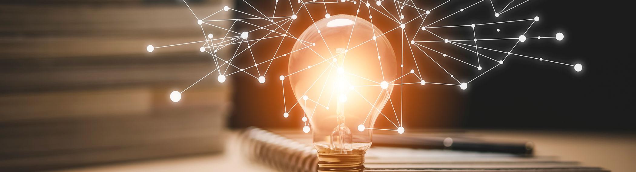 Lightbulb with knowledge spark network stretching out.