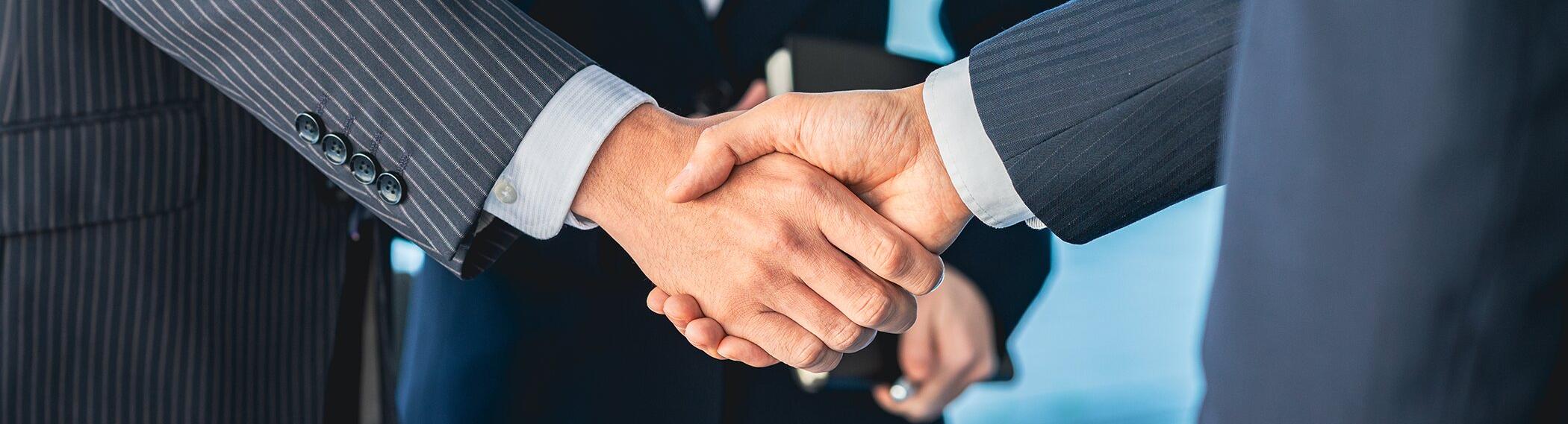Photo of two businessmen shaking hands.