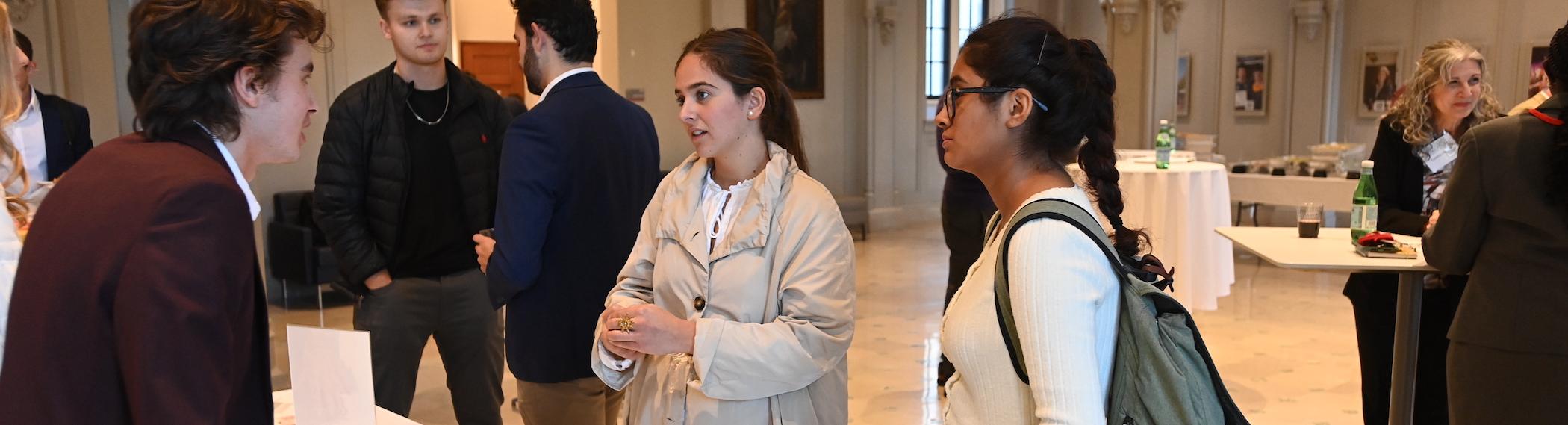 students talking to potential employers at an event on campus