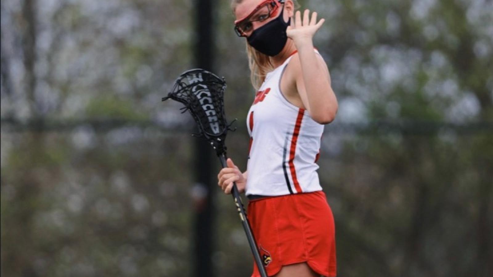 caroline playing lacrosse on the CUA team