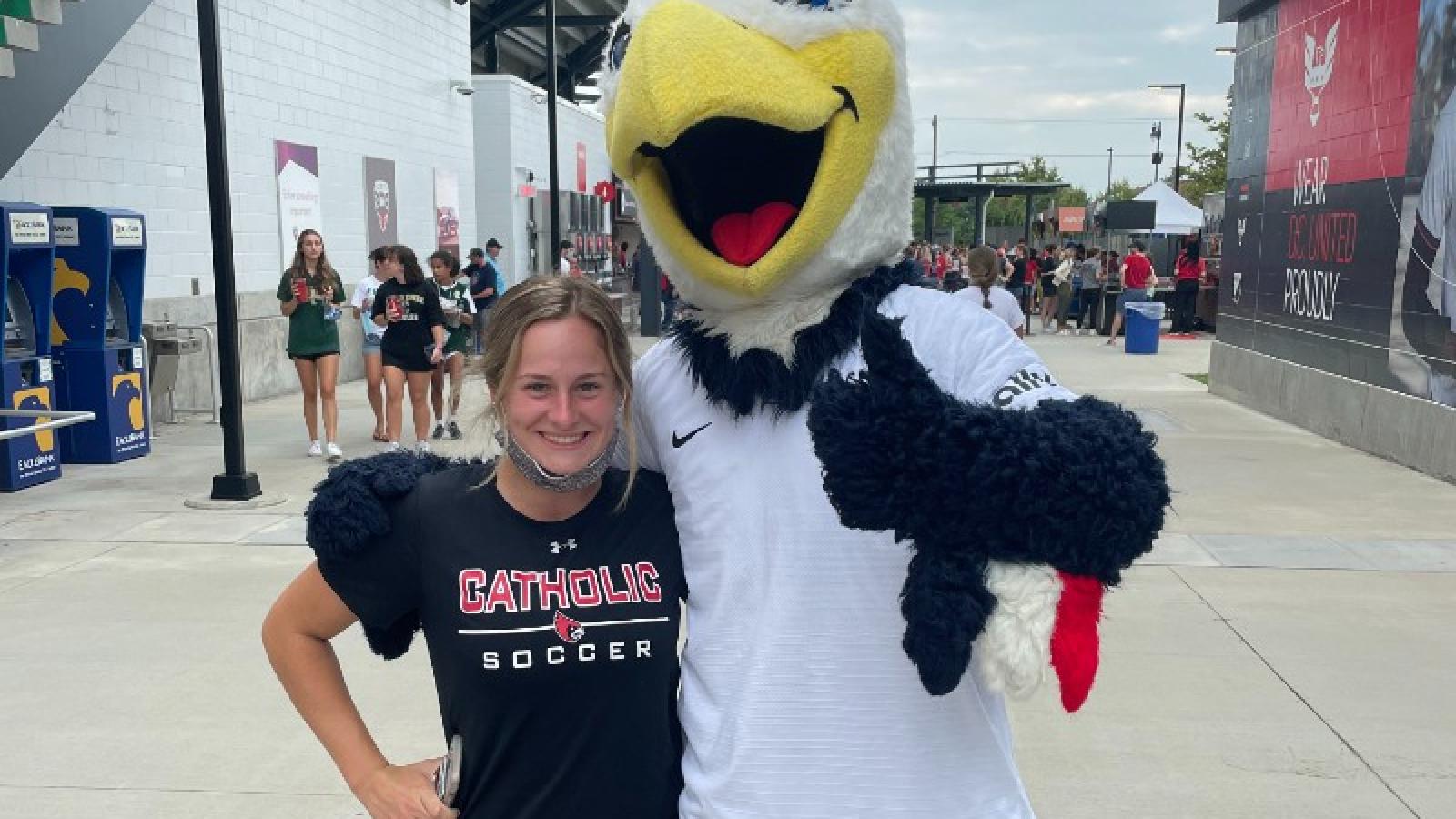 emily at a professional DC soccer game with the mascot
