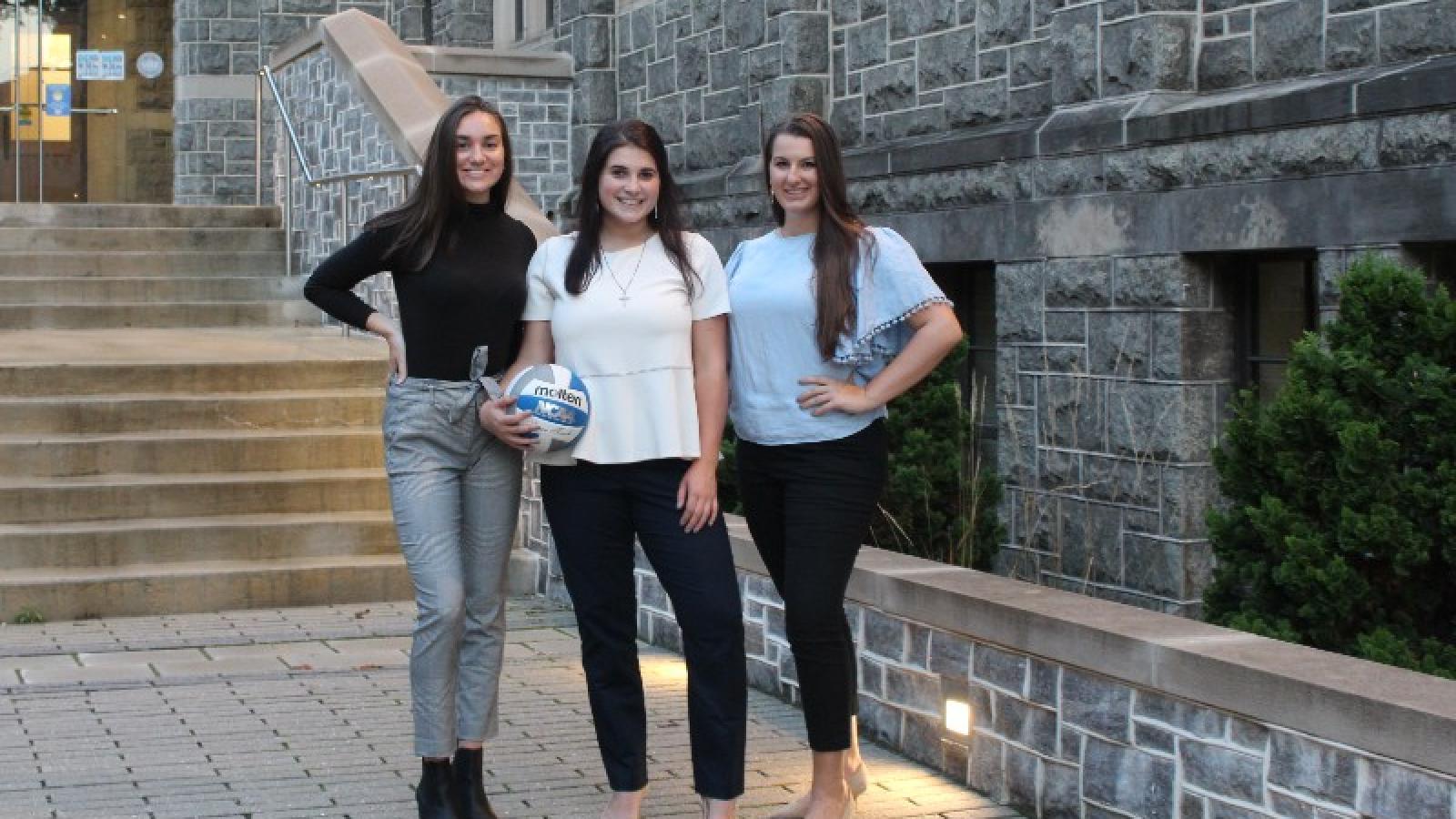 katie and some teammates in front of the busch school of business