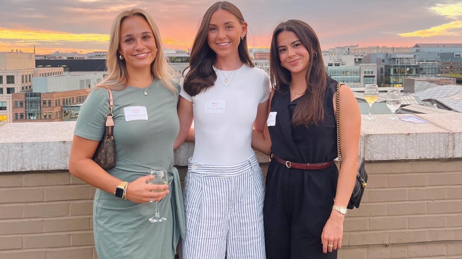 maeve and other classmates at a business event at a rooftop bar