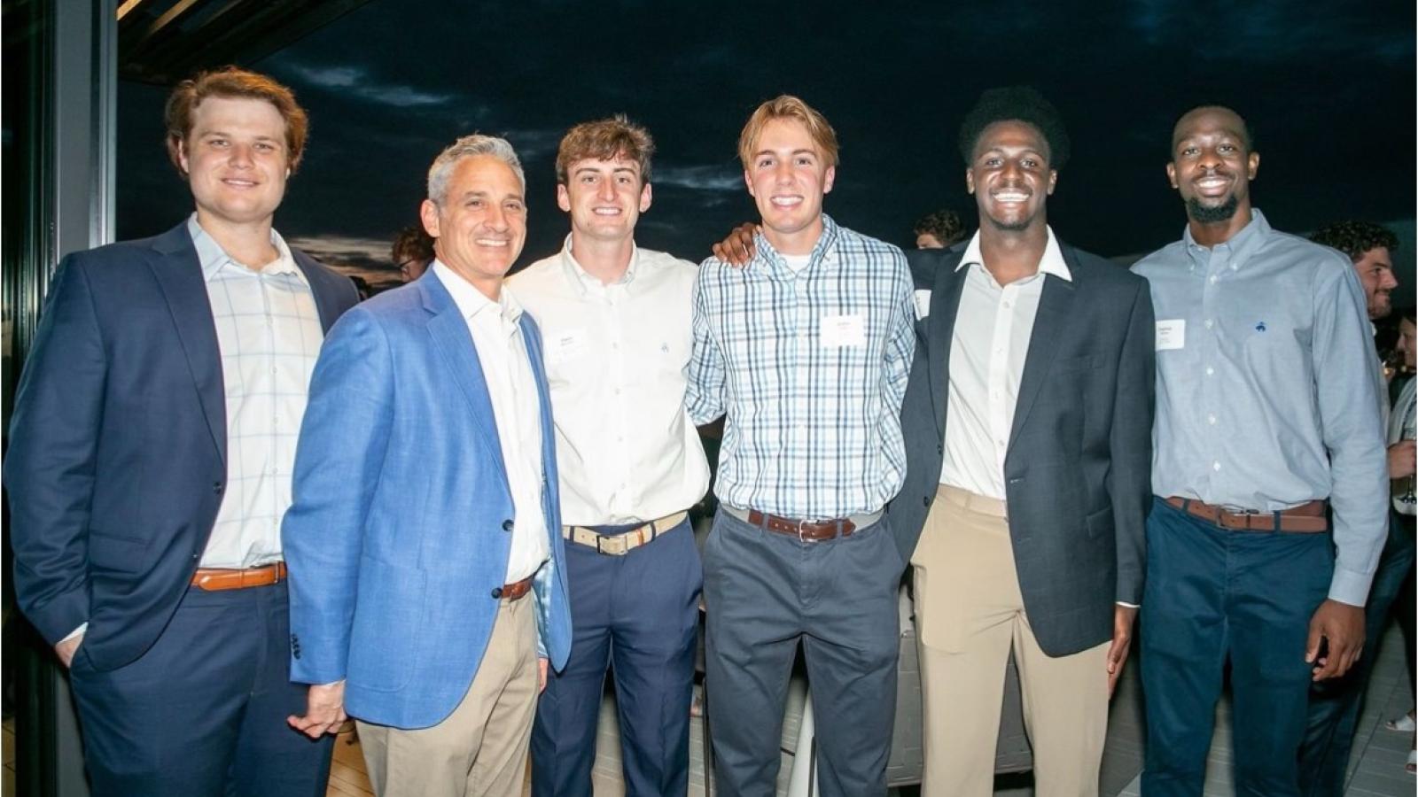 owen and his business school friends dressed in business casual attire