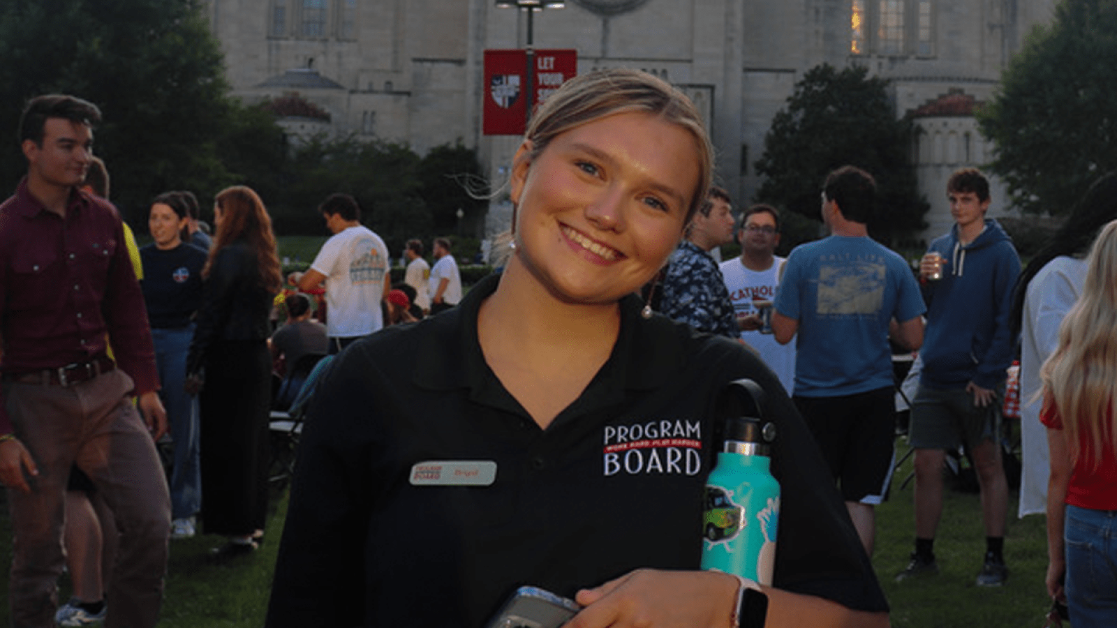 brigid at a Program Board event on campus wearing a program board polo