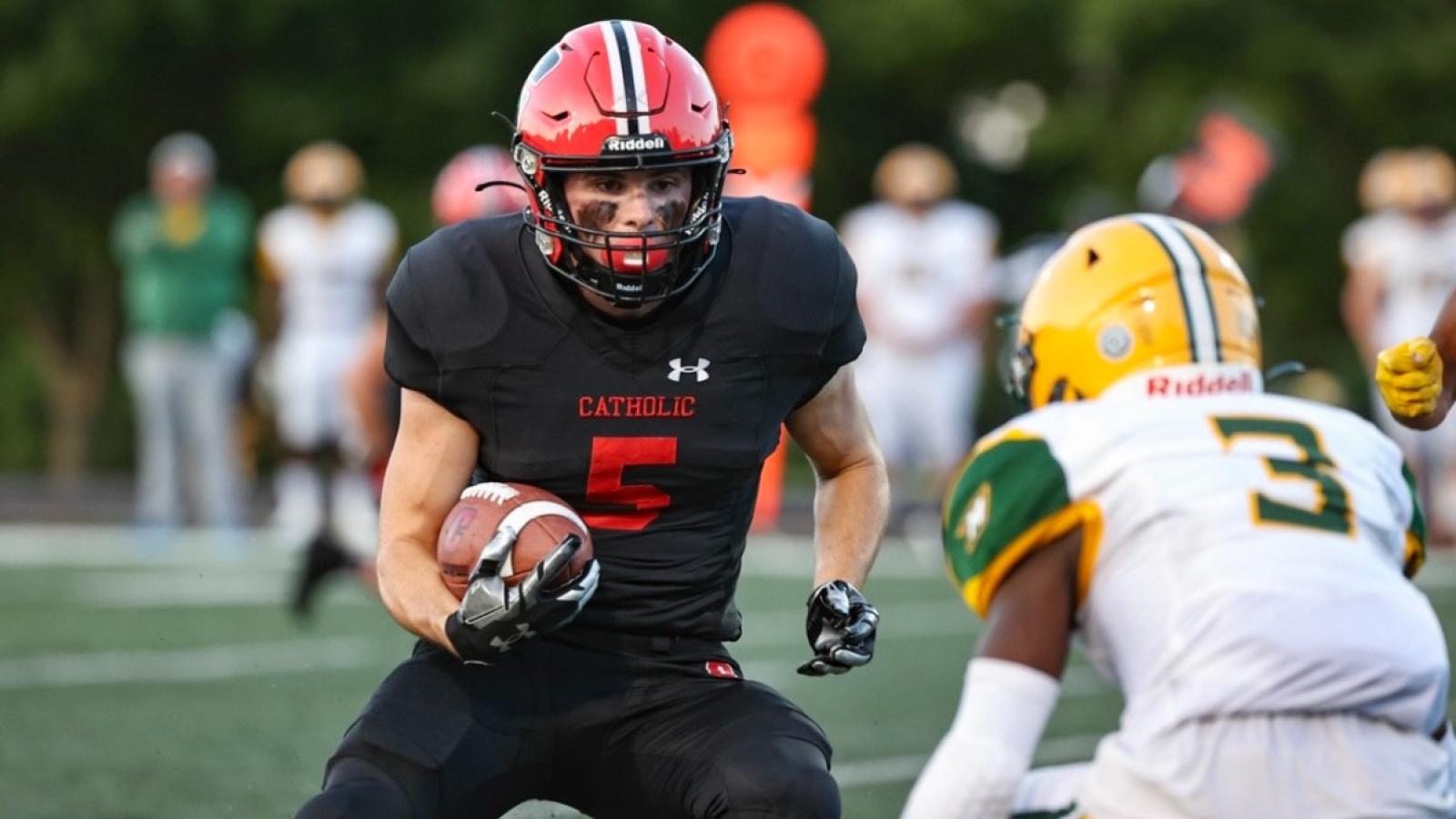 ryan playing football on the CUA team