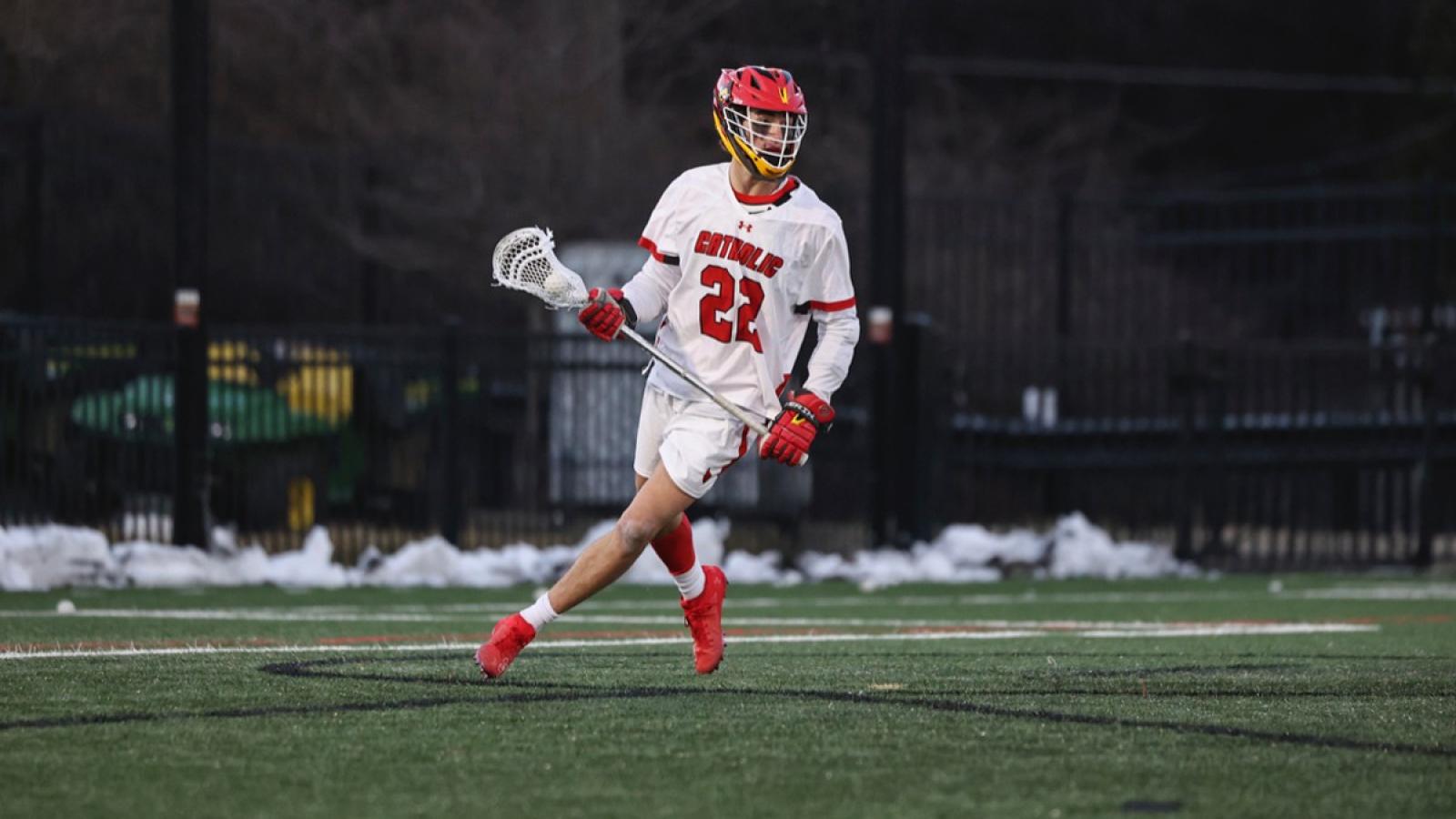 victor playing lacrosse on the CUA men's team