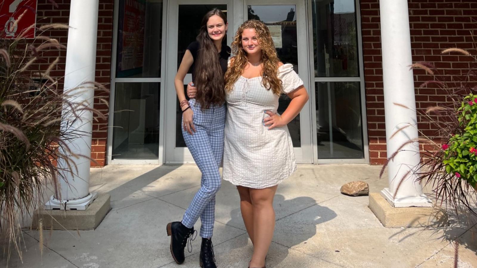 erin and a friend at the door of their residence hall