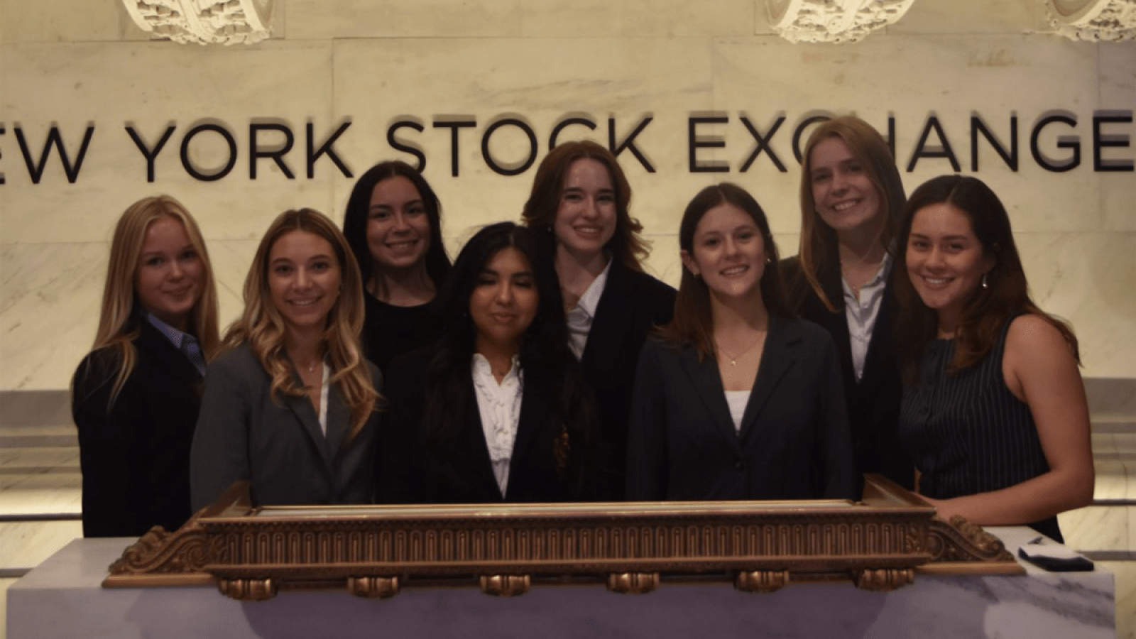 Monica and business school friends at the New York Stock Exchange