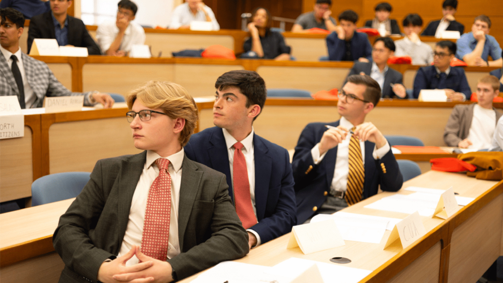 William listening intently at a conference