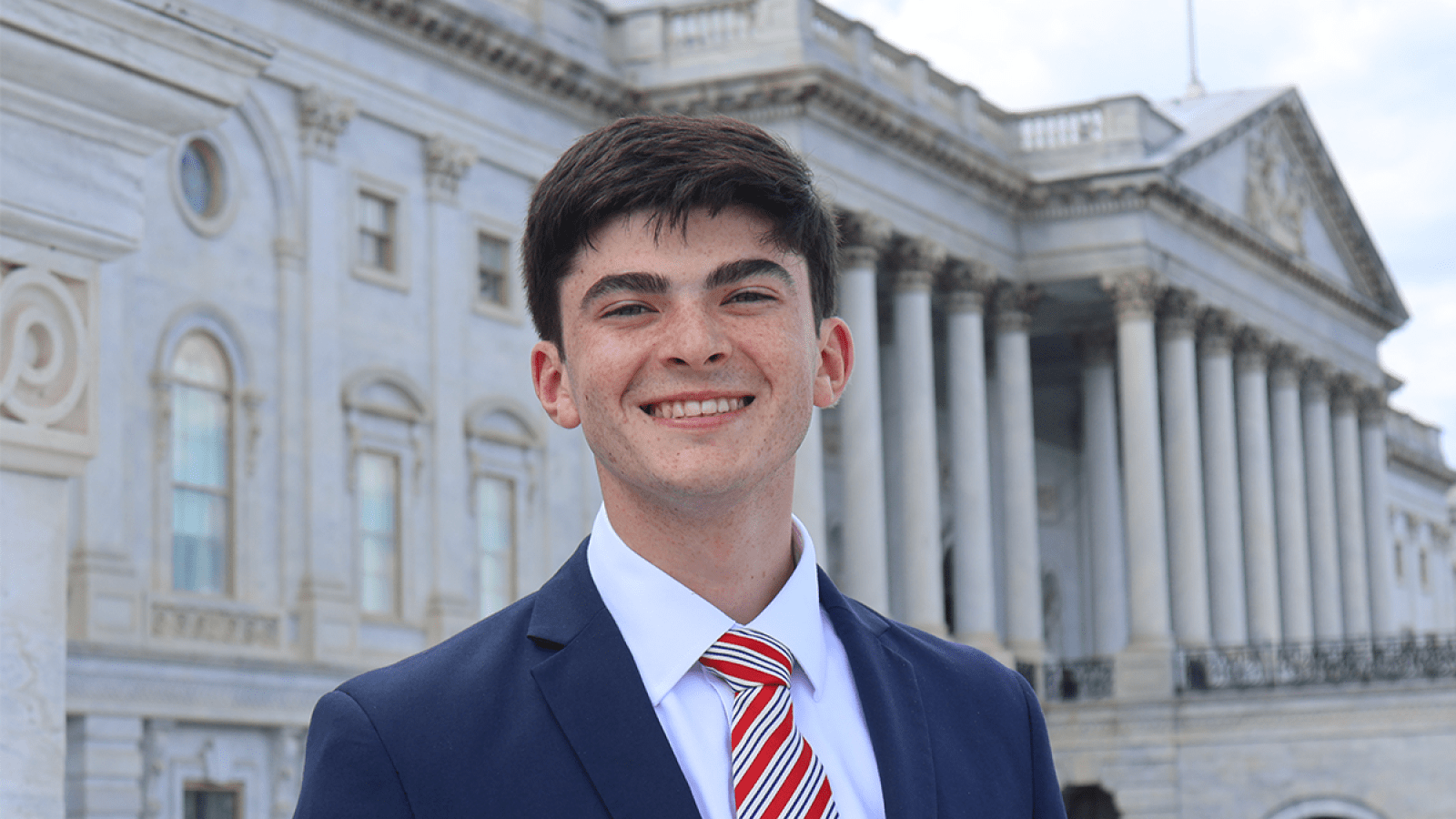 william headshot outside of a government building
