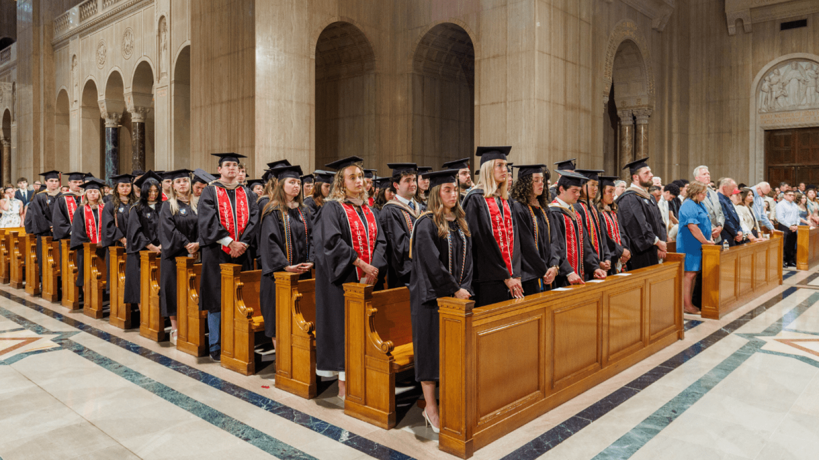 Students standing at their Commencement.