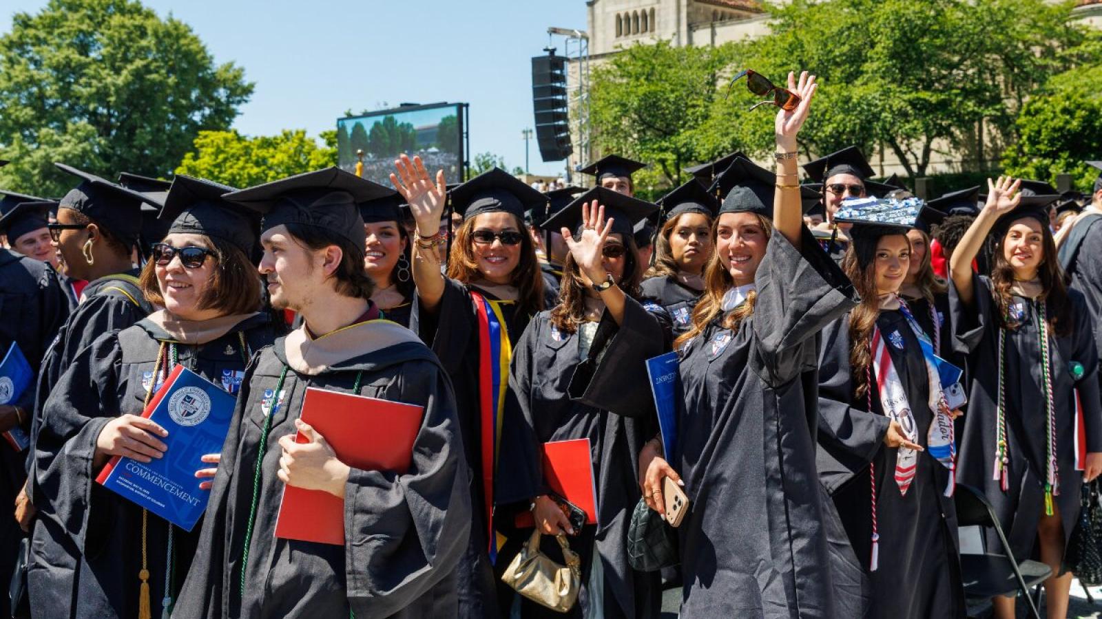 Students arriving to their Commencement ceremony, wearing their regalia.