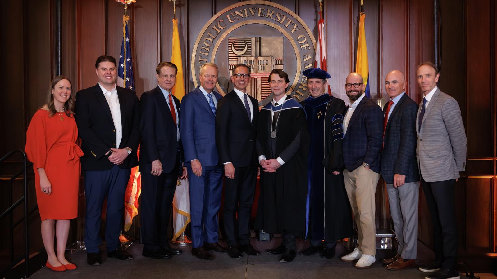 Professor Nicholas Schmitz with members of the Busch School board of trustees