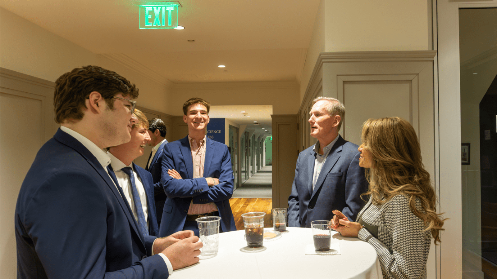 Brian Hamilton speaking to Busch students after his talk at a circular table in Maloney Hall.