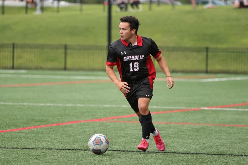 adam playing soccer on the CUA team