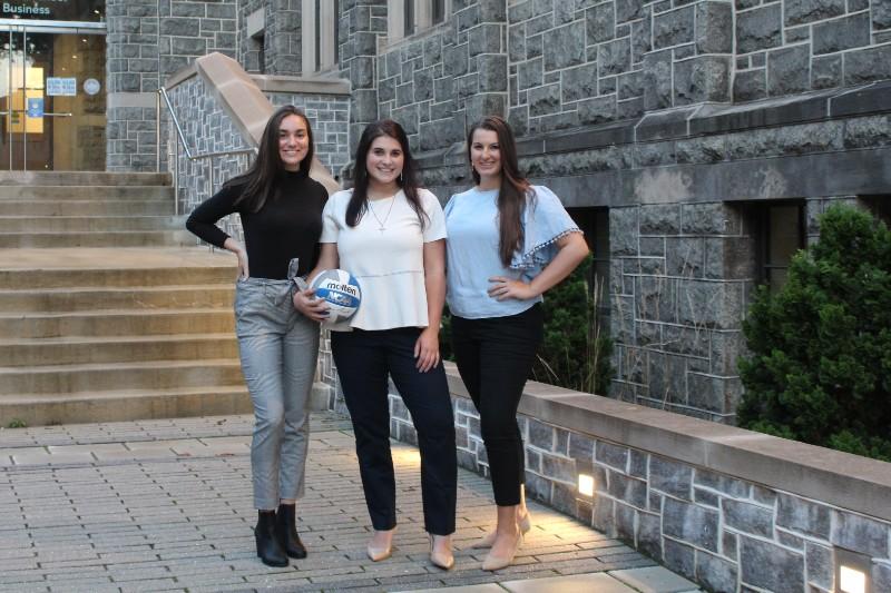 katie and some teammates in front of the busch school of business