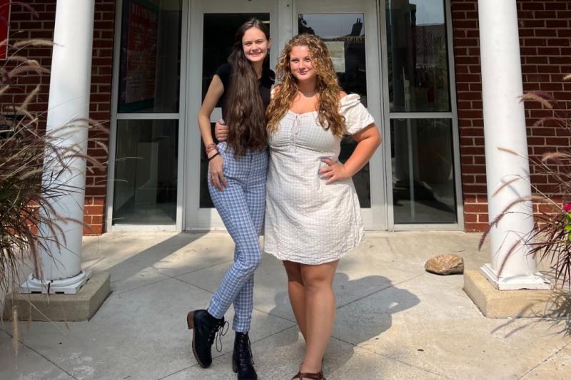 erin and a friend at the door of their residence hall