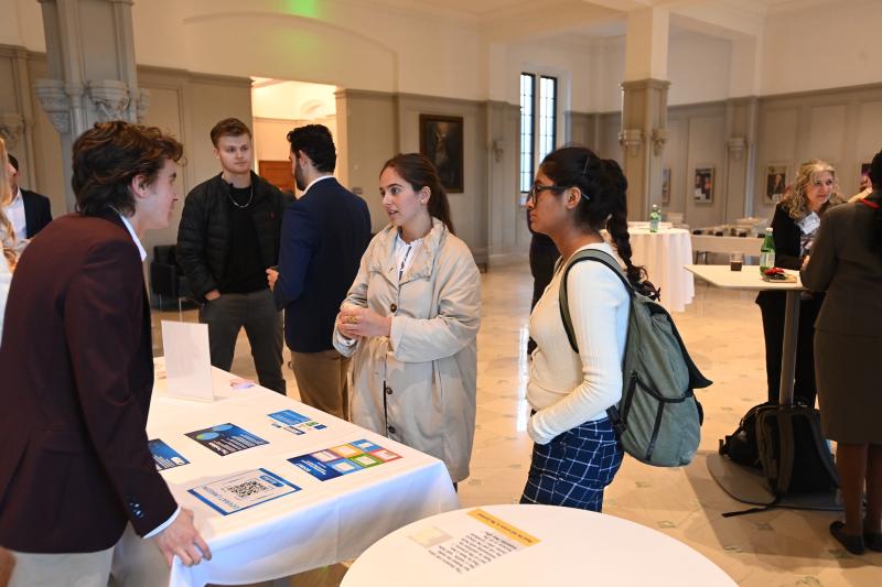 students talking to potential employers at an event on campus