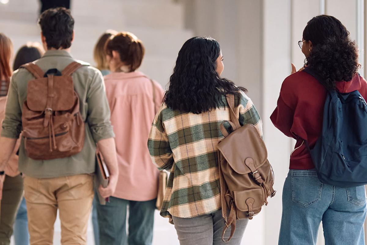 High school students walking towards stairs.