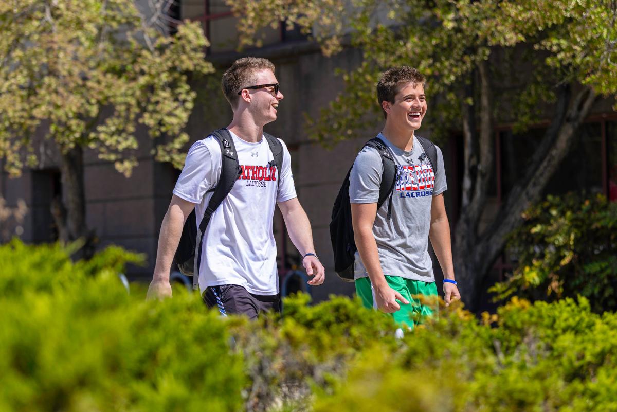 Two undergrads walking on campus.