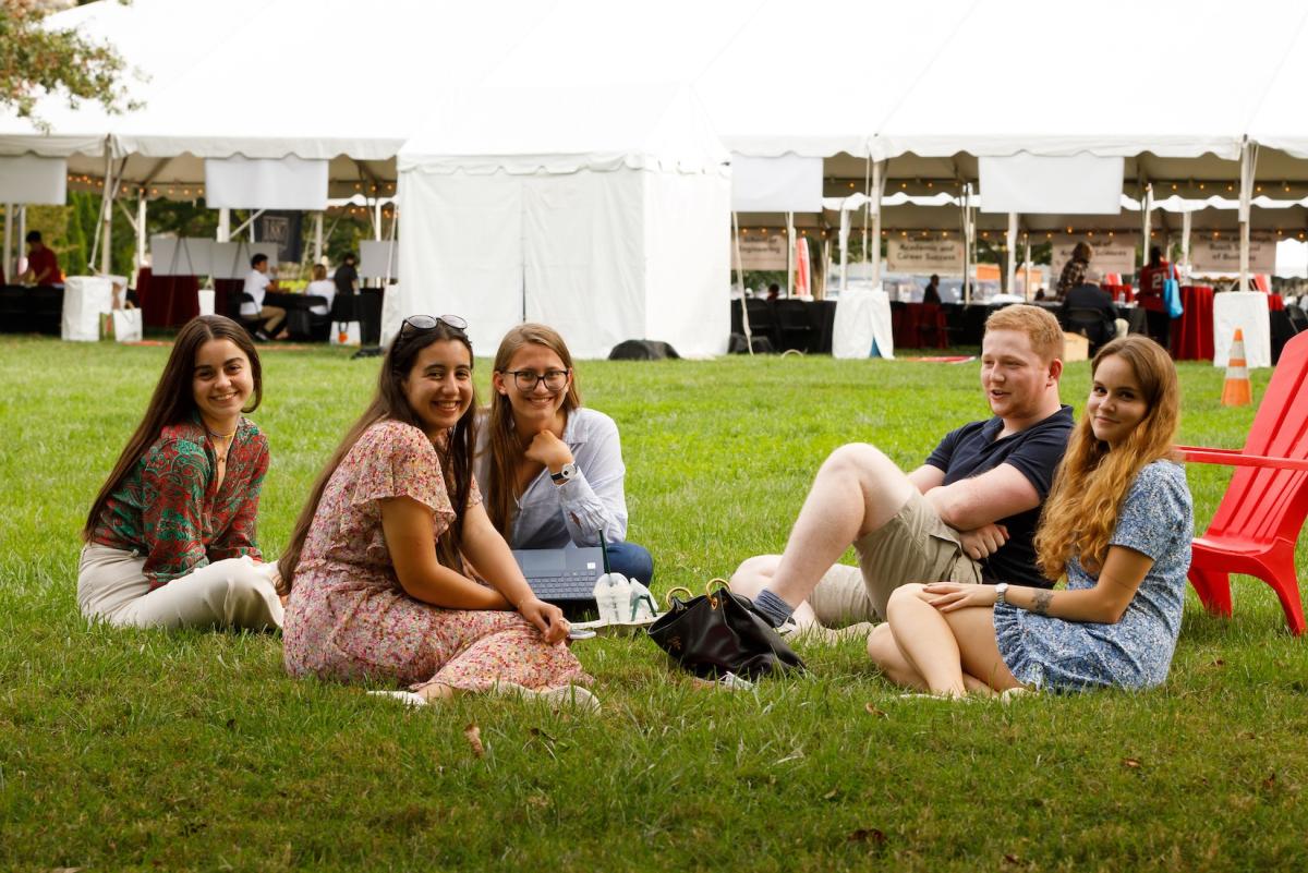 international students chatting in a circle on the lawn