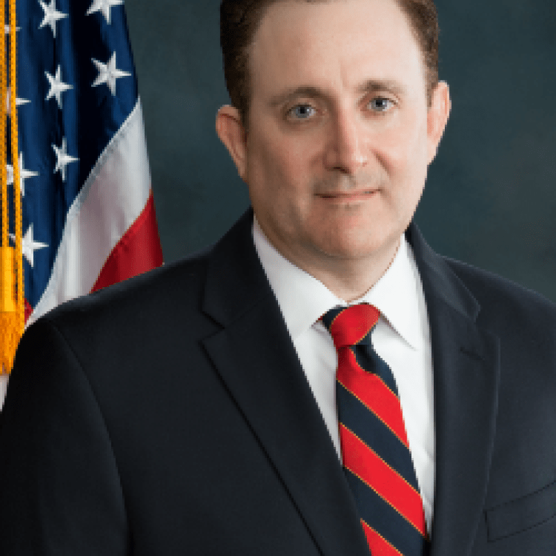 Photo of David Gortler. He has short brown hair and is wearing a black suit with a blue and white tie.