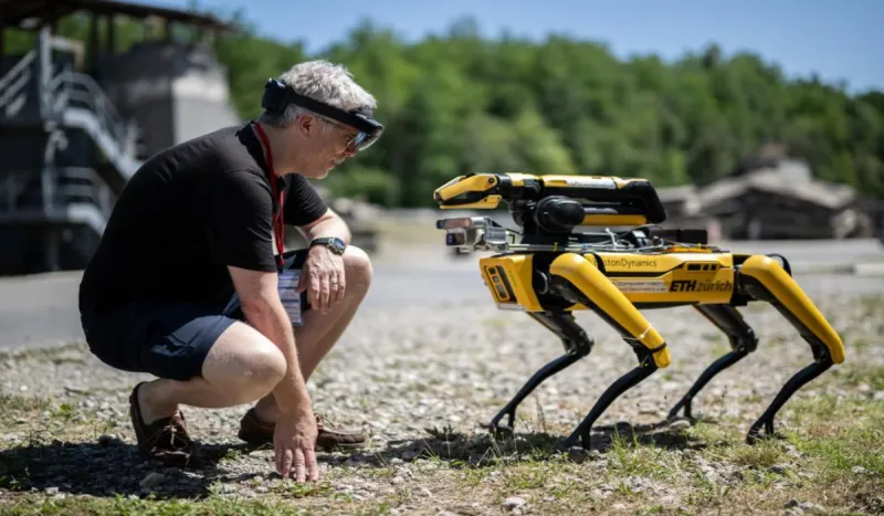 a person looking eye to eye at a robot dog