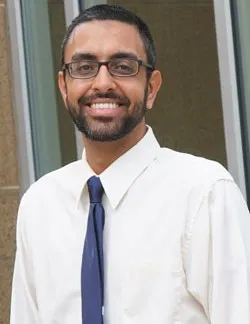 Photo of Robert Felix. He has short dark hair, thin glasses, and is wearing a white shirt with a blue tie.
